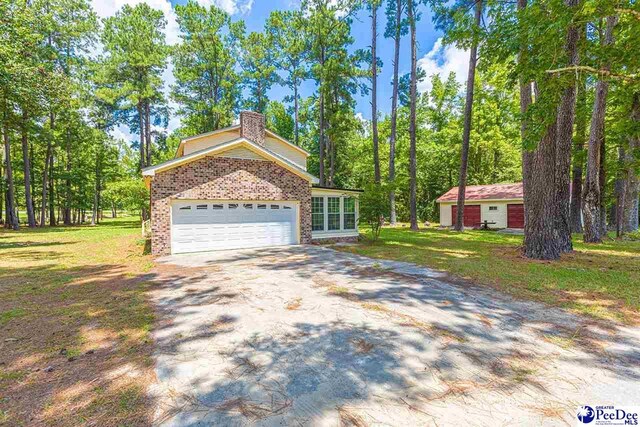 view of front facade with a garage and a front lawn