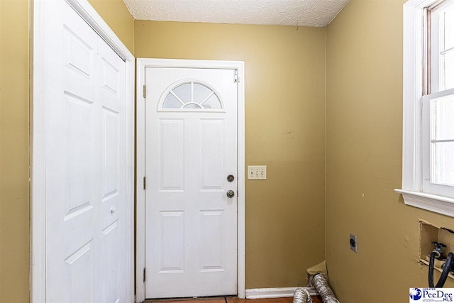 washroom featuring washer hookup, hookup for an electric dryer, and a textured ceiling