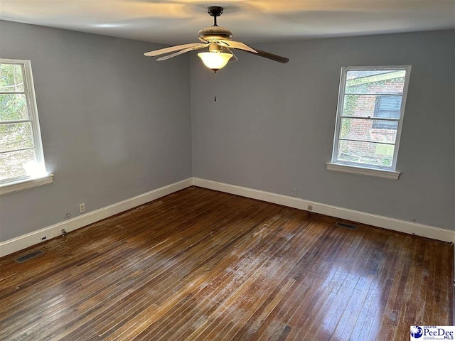 spare room featuring dark hardwood / wood-style floors and ceiling fan