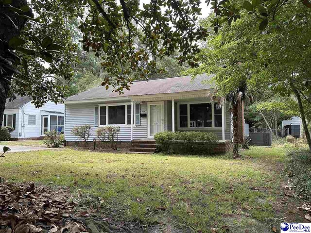 ranch-style home featuring central AC and a front yard