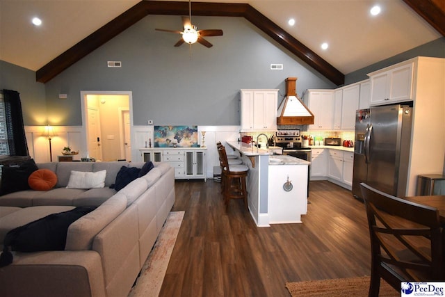 3804 Beckford St, Florence, SC 29501 - kitchen with appliances with stainless steel finishes, open floor plan, custom exhaust hood, a peninsula, and high vaulted ceiling