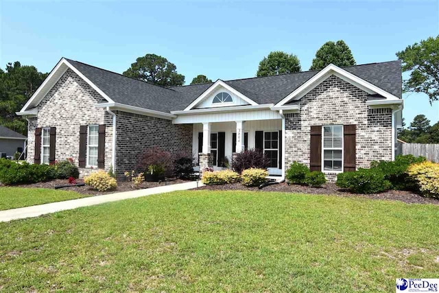 3804 Beckford St, Florence, SC 29501 - view of front of property featuring brick siding, a front lawn, a porch, and a shingled roof