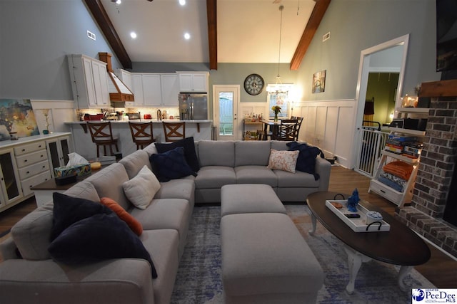 3804 Beckford St, Florence, SC 29501 - living room featuring dark wood finished floors, a wainscoted wall, and a chandelier