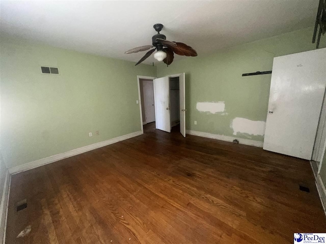 unfurnished bedroom featuring dark hardwood / wood-style floors and ceiling fan