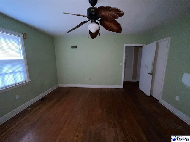 unfurnished room featuring dark hardwood / wood-style flooring and ceiling fan