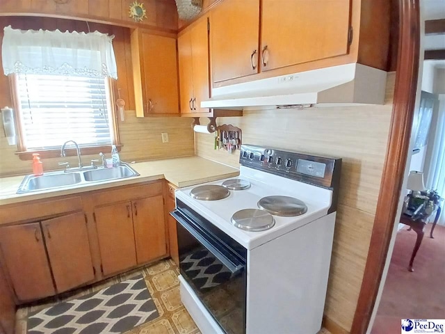 kitchen with tasteful backsplash, white electric stove, and sink