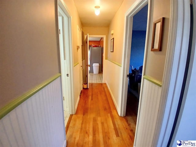 hallway with light hardwood / wood-style flooring