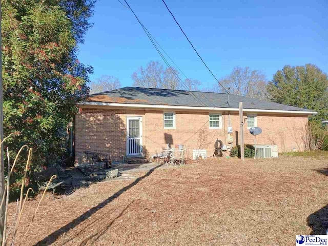 rear view of property featuring central AC unit