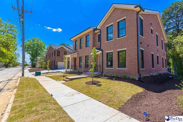 125 E Pine St, Florence, SC 29506 - view of front of property featuring brick siding and a front yard