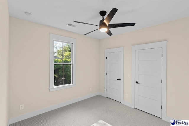 125 E Pine St, Florence, SC 29506 - unfurnished bedroom with light carpet and ceiling fan