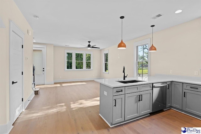 125 E Pine St, Florence, SC 29506 - kitchen with stainless steel dishwasher, gray cabinets, light wood-style floors, ceiling fan, and recessed lighting