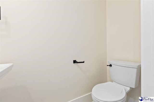125 E Pine St, Florence, SC 29506 - bathroom with toilet and baseboards