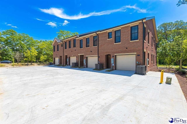 125 E Pine St, Florence, SC 29506 - view of front of home featuring an attached garage, driveway, and brick siding