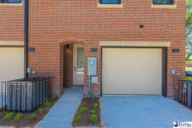 125 E Pine St, Florence, SC 29506 - doorway to property with a garage, brick siding, and driveway