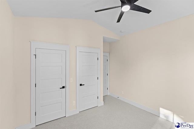 125 E Pine St, Florence, SC 29506 - unfurnished bedroom featuring light colored carpet, vaulted ceiling, and a ceiling fan