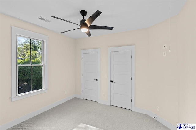 125 E Pine St, Florence, SC 29506 - unfurnished bedroom featuring light carpet and ceiling fan