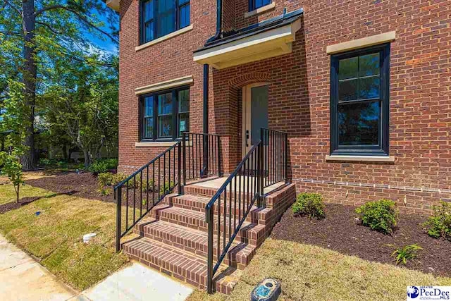 125 E Pine St, Florence, SC 29506 - doorway to property featuring brick siding