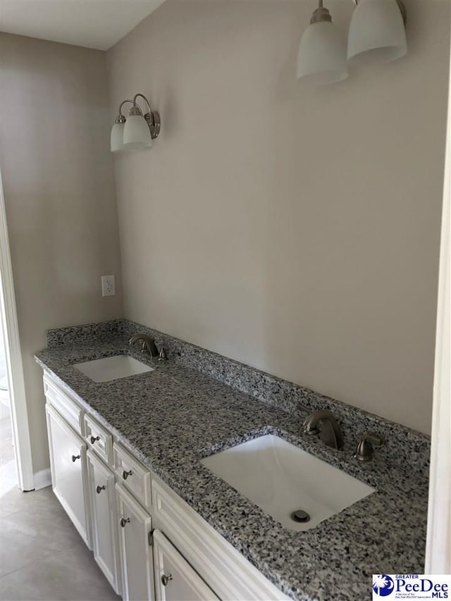 bathroom featuring double vanity and a sink
