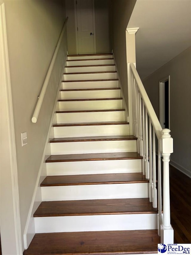 staircase featuring wood finished floors