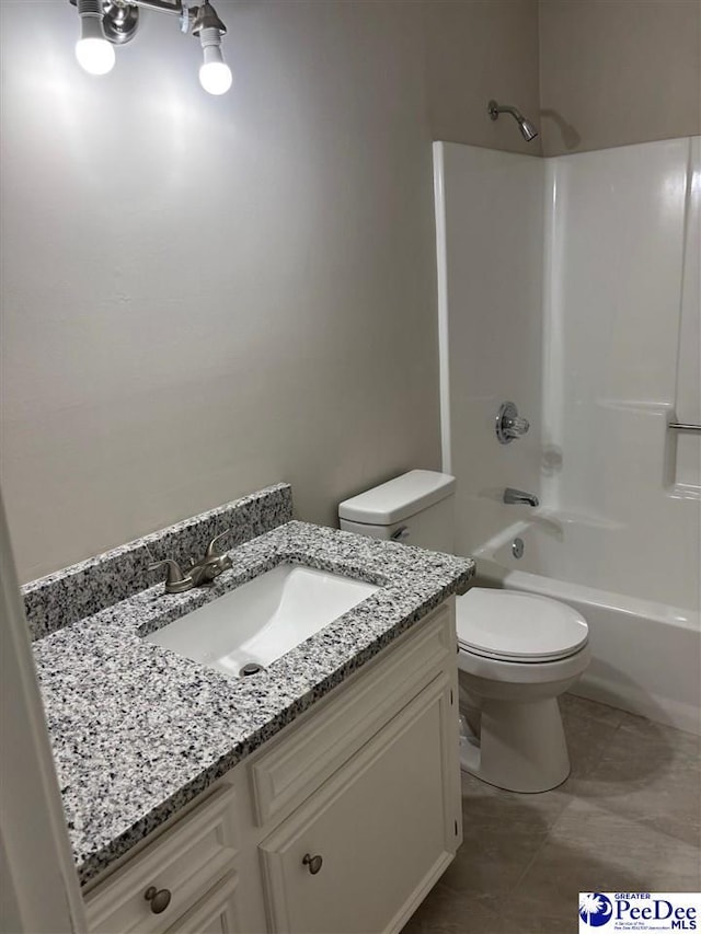 bathroom with toilet, tile patterned flooring, bathing tub / shower combination, and vanity