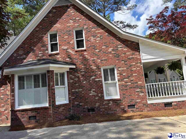 view of property exterior featuring brick siding and crawl space
