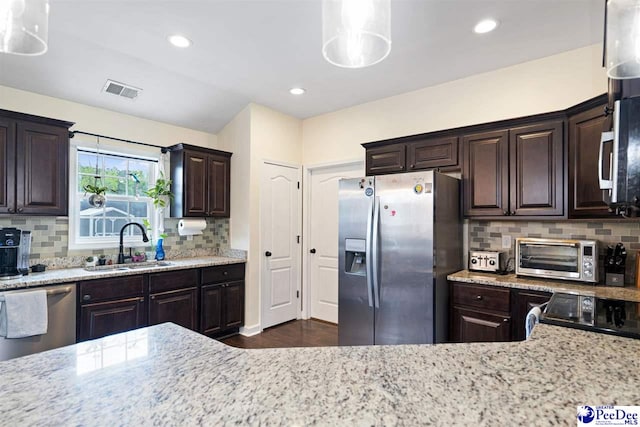 170 Dogwood Ave, Darlington, SC 29532 - kitchen featuring dark brown cabinetry, a toaster, light stone countertops, appliances with stainless steel finishes, and a sink