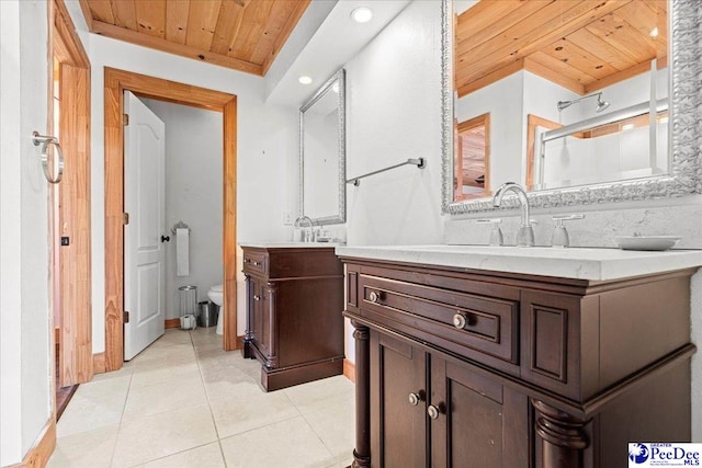 bathroom with toilet, wooden ceiling, a shower with shower door, tile patterned floors, and vanity