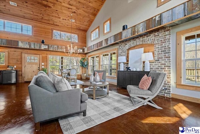 living room with a healthy amount of sunlight, a notable chandelier, and baseboards