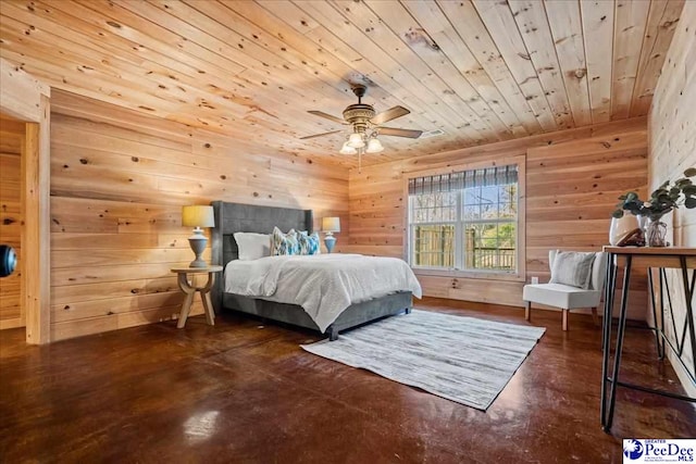 bedroom with wood walls, concrete floors, and wooden ceiling