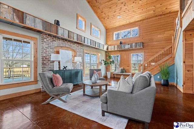 living area featuring wood walls, wood ceiling, stairs, and baseboards