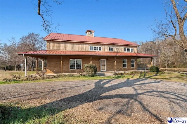 view of front facade with covered porch and metal roof