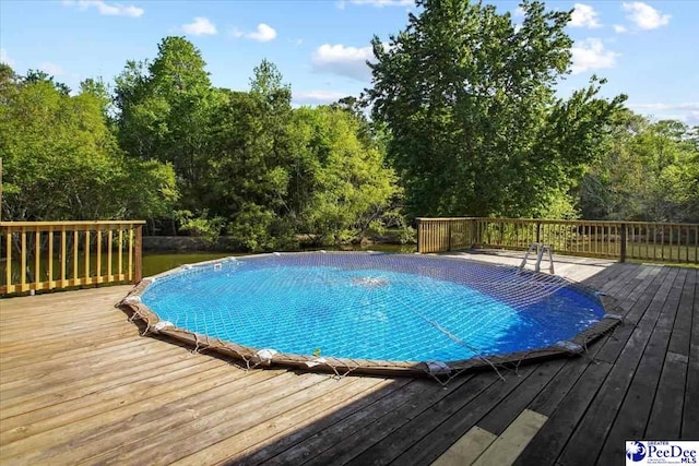 view of pool with a wooden deck