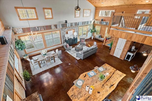 living area with stairway and high vaulted ceiling