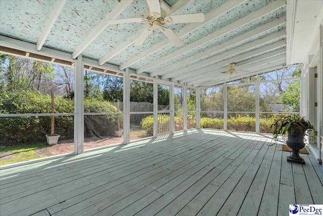 unfurnished sunroom with a ceiling fan and lofted ceiling