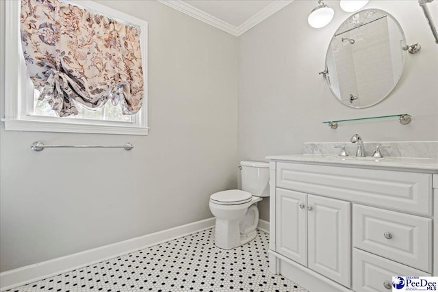 bathroom featuring baseboards, toilet, vanity, and crown molding