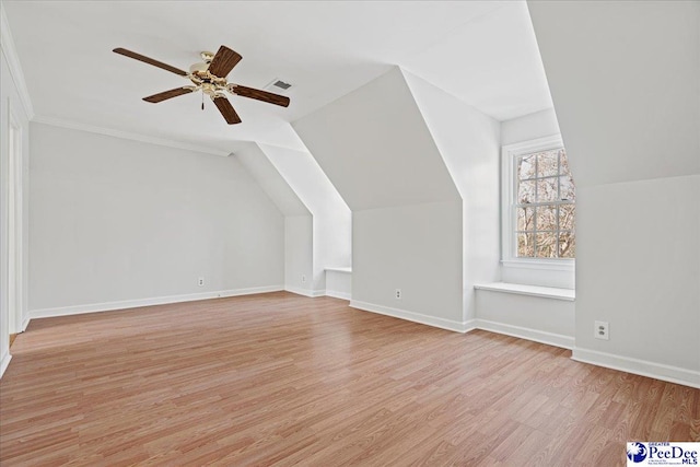 bonus room with lofted ceiling, ceiling fan, visible vents, baseboards, and light wood finished floors