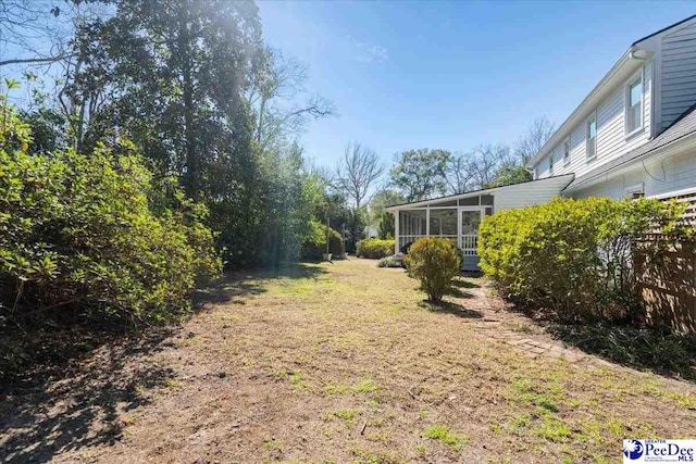 view of yard featuring a sunroom