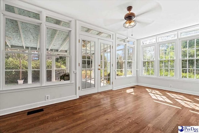 unfurnished sunroom featuring ceiling fan and visible vents