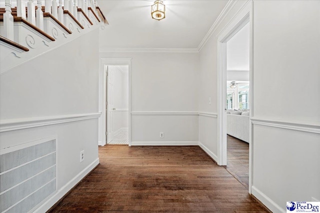 interior space with dark wood-style floors, baseboards, and ornamental molding