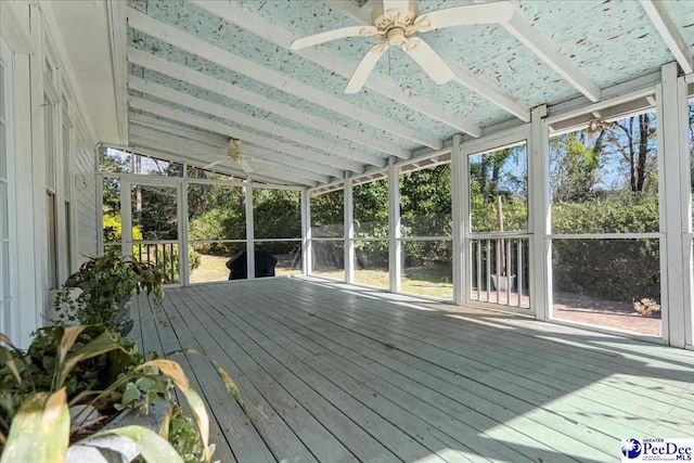 unfurnished sunroom featuring vaulted ceiling and a ceiling fan