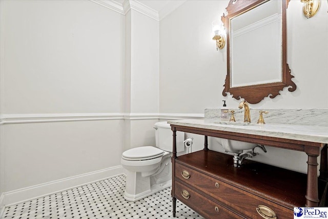 half bathroom with ornamental molding, baseboards, and toilet