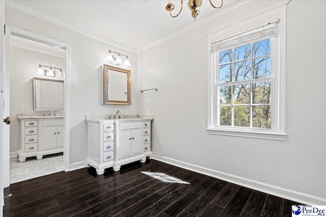 bathroom with baseboards, wood finished floors, and crown molding