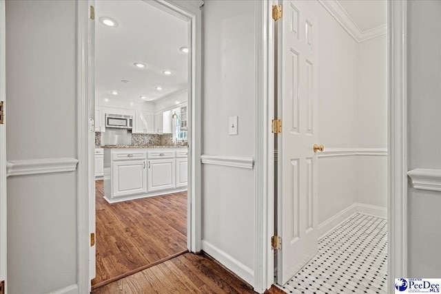 hall with ornamental molding, recessed lighting, baseboards, and wood finished floors