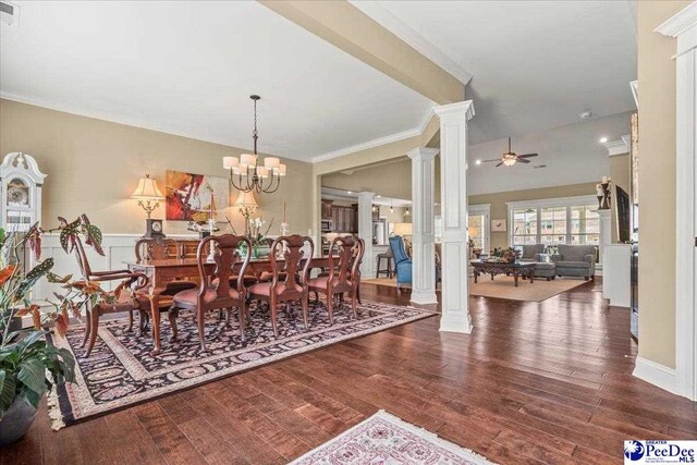 3111 Cheshire Ln, Florence, SC 29501 - dining room with ornate columns, wood finished floors, ornamental molding, ceiling fan, and a chandelier