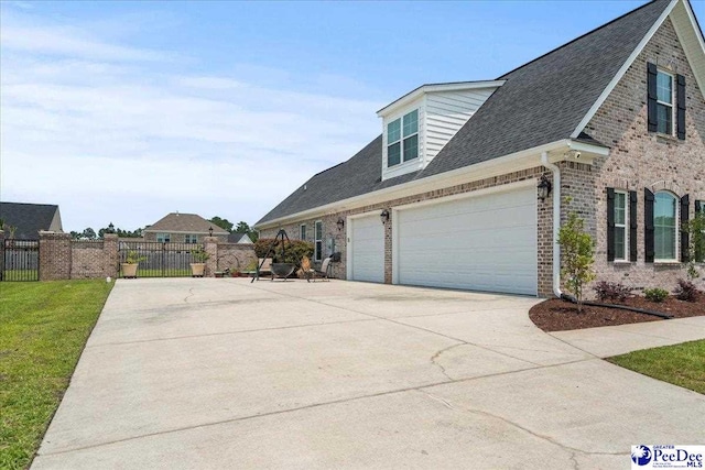3111 Cheshire Ln, Florence, SC 29501 - view of side of property with concrete driveway, brick siding, roof with shingles, and an attached garage
