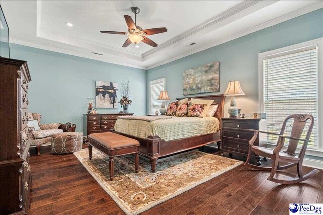 3111 Cheshire Ln, Florence, SC 29501 - bedroom featuring dark wood-type flooring, a raised ceiling, multiple windows, crown molding, and a ceiling fan
