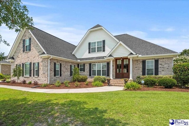 3111 Cheshire Ln, Florence, SC 29501 - view of front of property with brick siding, a front yard, french doors, and roof with shingles