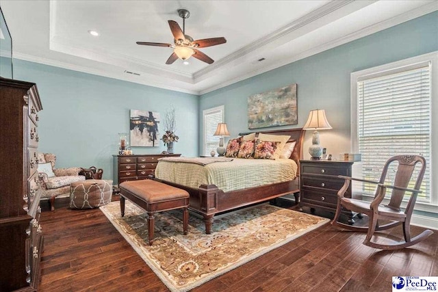 3111 Cheshire Ln, Florence, SC 29501 - bedroom featuring dark wood-type flooring, a raised ceiling, multiple windows, crown molding, and a ceiling fan