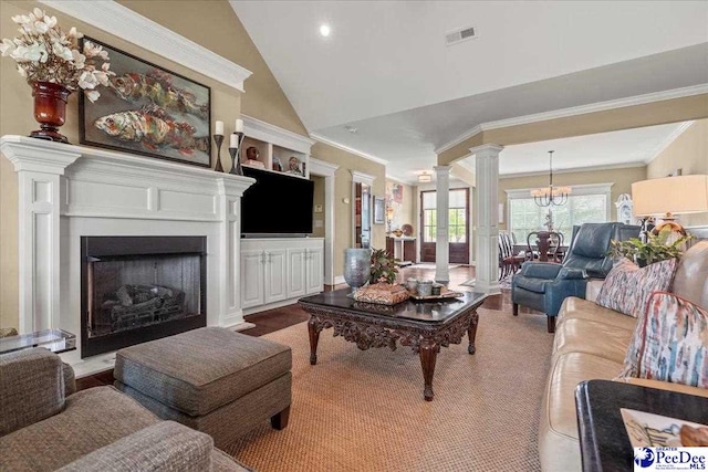 3111 Cheshire Ln, Florence, SC 29501 - living area with ornamental molding, decorative columns, a fireplace with raised hearth, vaulted ceiling, and a chandelier
