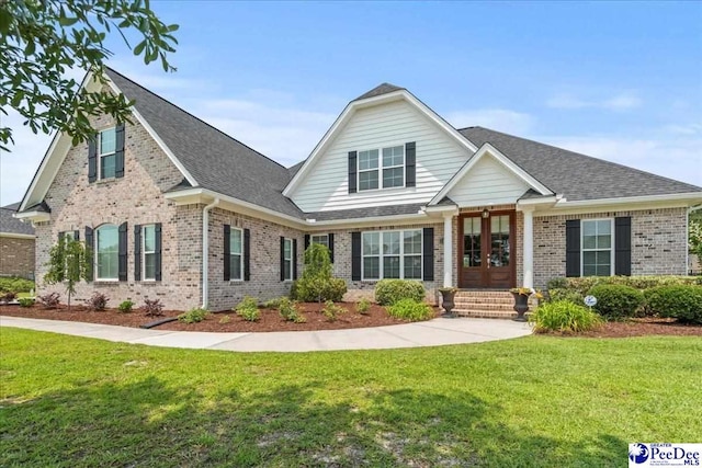 3111 Cheshire Ln, Florence, SC 29501 - view of front facade featuring french doors, brick siding, a front yard, and a shingled roof